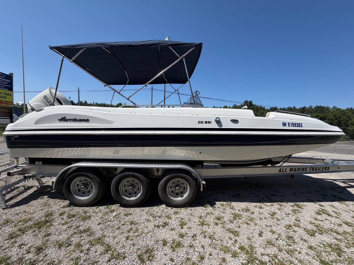 2017 Hurricane CC231 side profile with bimini top and Suzuki outboard